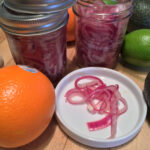 These pickled red onions are a tangy, slightly sweet, and downright magical addition to tacos, sandwiches, or anything that needs a zing of flavor. Quick, simple, and a total flavor bomb!