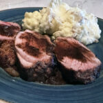 A perfectly seared pork tenderloin finished in the oven and topped with a rich, glossy Madeira sauce. This dish is surprisingly simple and seriously impressive.
